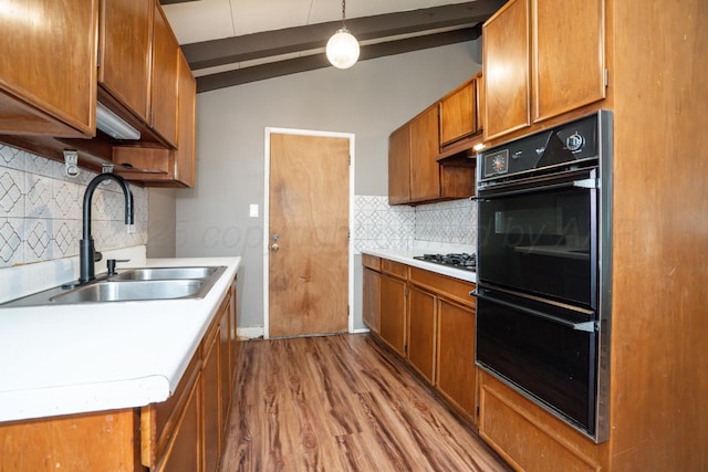 3110 S Apache St, Amarillo, TX 79103 - kitchen with lofted ceiling, brown cabinetry, light wood-style floors, light countertops, and tasteful backsplash