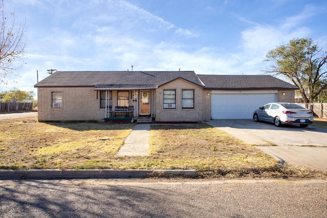 ranch-style house featuring a garage and a front yard