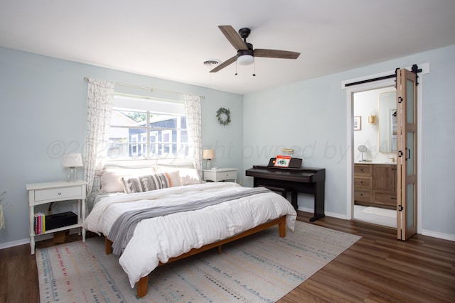 3509 Huntington Dr, Amarillo, TX 79109 - bedroom with wood finished floors, connected bathroom, a ceiling fan, and a barn door
