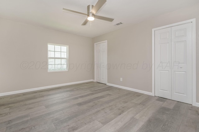 918 N Gray St, Amarillo, TX 79065 - unfurnished bedroom with multiple closets, light wood-style floors, and a ceiling fan