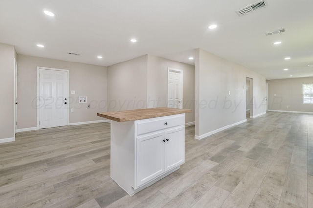 918 N Gray St, Amarillo, TX 79065 - kitchen featuring open floor plan, butcher block countertops, light wood-style floors, white cabinets, and recessed lighting