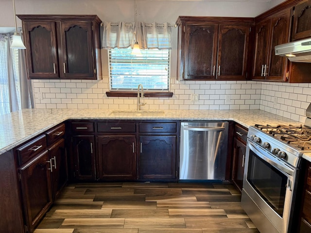 805 Skyline Dr, Borger, TX 79007 - kitchen featuring appliances with stainless steel finishes, a sink, extractor fan, light stone countertops, and decorative backsplash
