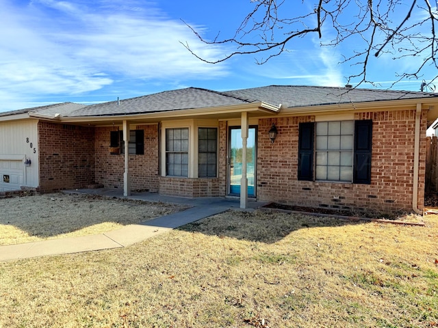 single story home featuring an attached garage, brick siding, a front lawn, and a shingled roof