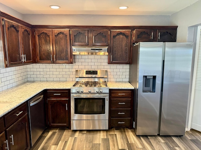 805 Skyline Dr, Borger, TX 79007 - kitchen with stainless steel appliances, under cabinet range hood, light wood-style floors, recessed lighting, and light stone countertops