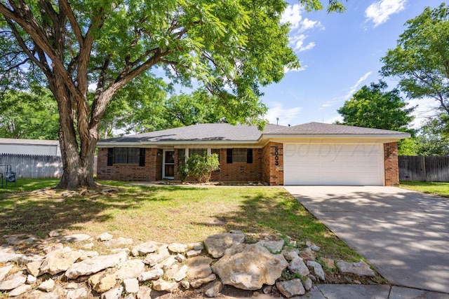 5003 Greenway Pl, Amarillo, TX 79109 - ranch-style home featuring a garage, brick siding, and driveway