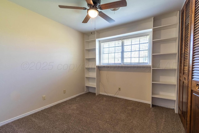 carpeted spare room with ceiling fan and baseboards