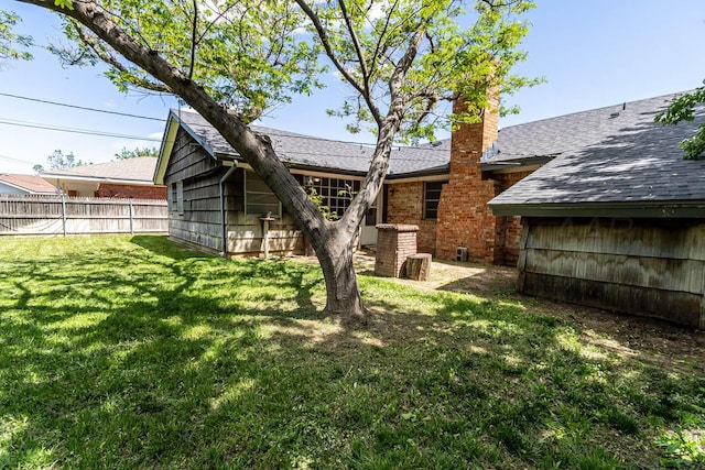 back of property with a chimney and a shingled roof