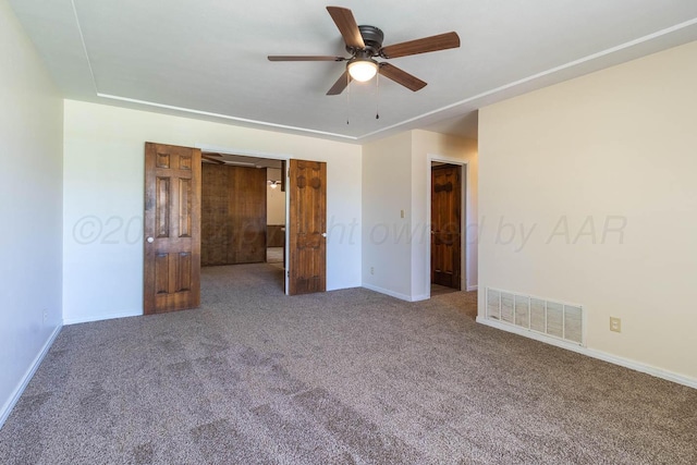 unfurnished bedroom featuring carpet, baseboards, and a ceiling fan