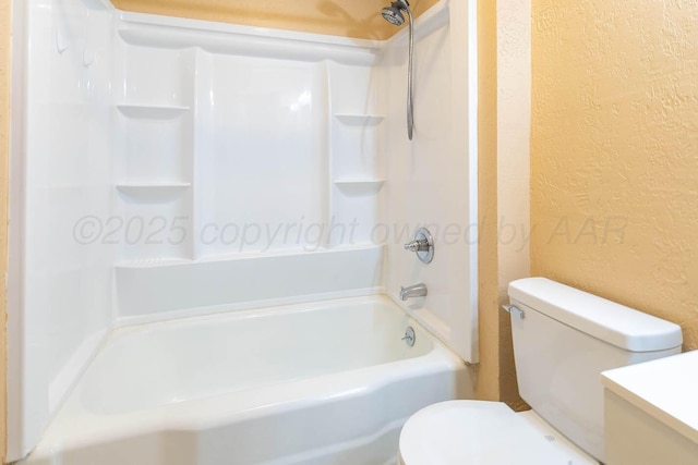full bath featuring a textured wall, toilet, and washtub / shower combination