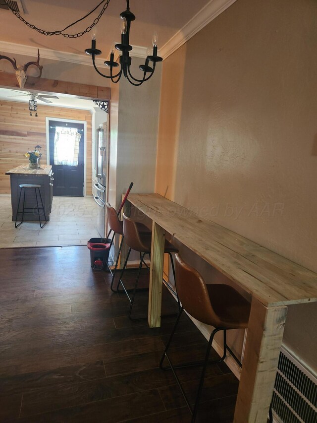 3114 Palm St, Amarillo, TX 79107 - dining space with ornamental molding, a chandelier, and wood finished floors