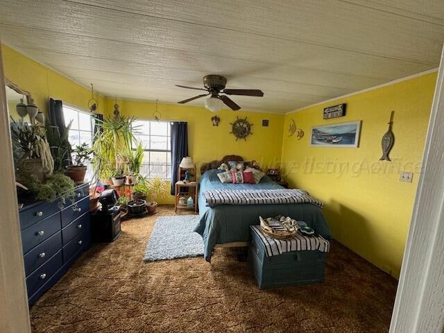 carpeted bedroom featuring a textured ceiling and ceiling fan