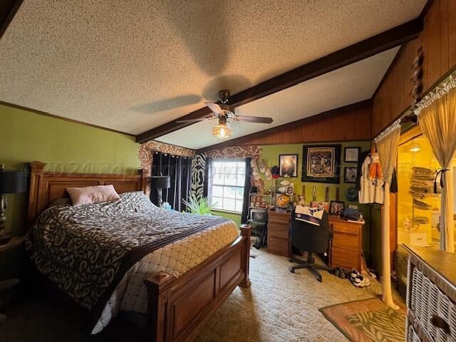 bedroom with lofted ceiling with beams, a textured ceiling, wood walls, light colored carpet, and ceiling fan