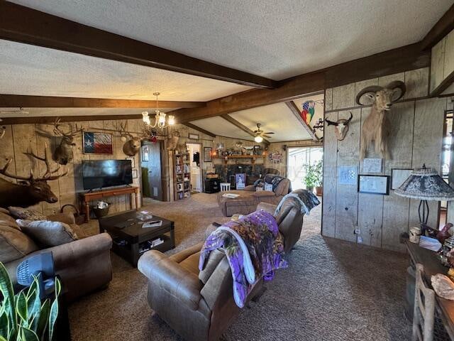 carpeted living room featuring a textured ceiling, ceiling fan with notable chandelier, and vaulted ceiling with beams