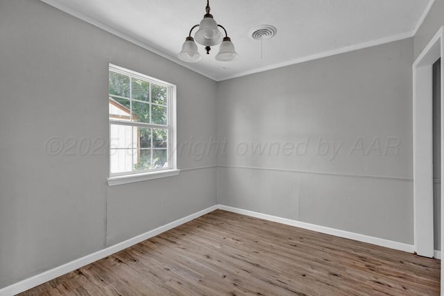4360 S Polk St, Amarillo, TX 79110 - spare room with a chandelier, wood finished floors, and crown molding
