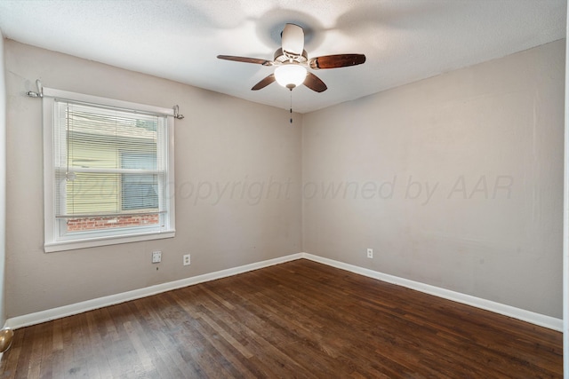 spare room with baseboards, ceiling fan, and hardwood / wood-style flooring