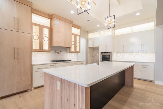 1207 Herring Ranch Rd, Amarillo, TX 79124 - kitchen featuring appliances with stainless steel finishes, a chandelier, tasteful backsplash, light wood finished floors, and recessed lighting