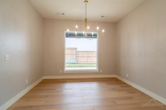 1207 Herring Ranch Rd, Amarillo, TX 79124 - unfurnished room with a chandelier and light wood-style flooring