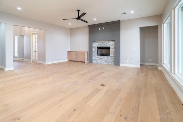 1207 Herring Ranch Rd, Amarillo, TX 79124 - unfurnished living room featuring a ceiling fan, light wood-style floors, a fireplace, healthy amount of natural light, and recessed lighting