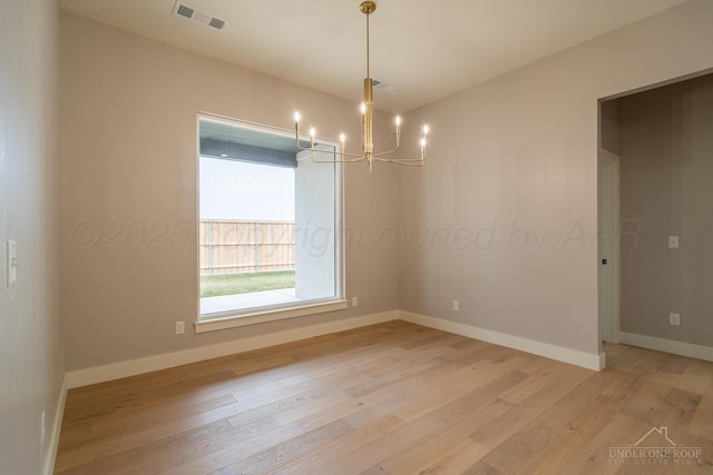1207 Herring Ranch Rd, Amarillo, TX 79124 - spare room featuring light wood-type flooring and a chandelier