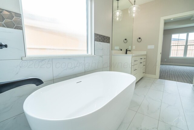 1207 Herring Ranch Rd, Amarillo, TX 79124 - bathroom featuring vanity, a freestanding bath, and marble look tile flooring