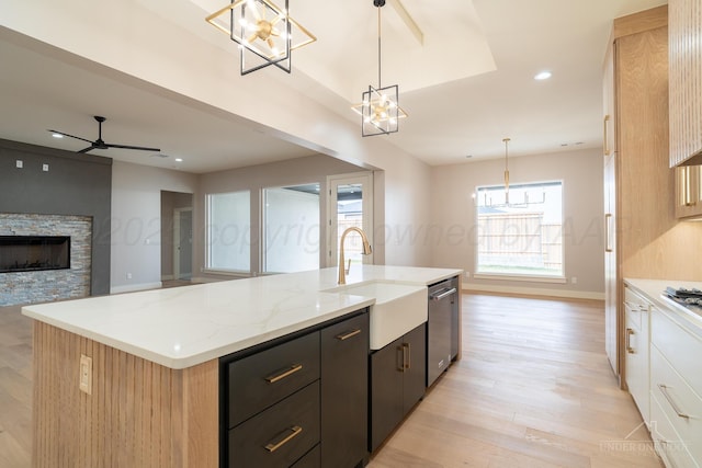 1207 Herring Ranch Rd, Amarillo, TX 79124 - kitchen with an island with sink, light wood-style flooring, a chandelier, stainless steel dishwasher, and recessed lighting