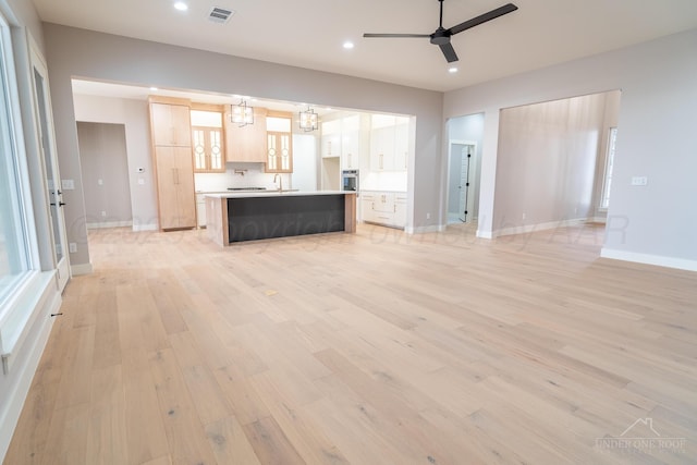 1207 Herring Ranch Rd, Amarillo, TX 79124 - unfurnished living room with light wood-type flooring, recessed lighting, a ceiling fan, and a chandelier