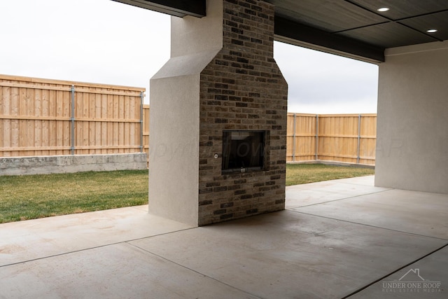 1207 Herring Ranch Rd, Amarillo, TX 79124 - fenced backyard with a fireplace and a patio area
