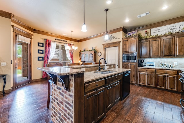 12 William Ln, Canyon, TX 79015 - kitchen with stainless steel microwave, dark wood-style flooring, crown molding, dishwasher, and a kitchen island with sink