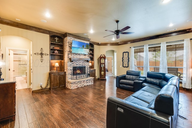 12 William Ln, Canyon, TX 79015 - living room with arched walkways, ceiling fan, a brick fireplace, dark wood finished floors, and recessed lighting