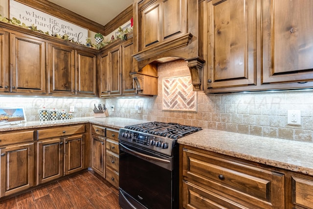 12 William Ln, Canyon, TX 79015 - kitchen featuring range with gas cooktop, light stone countertops, crown molding, tasteful backsplash, and dark wood-style flooring