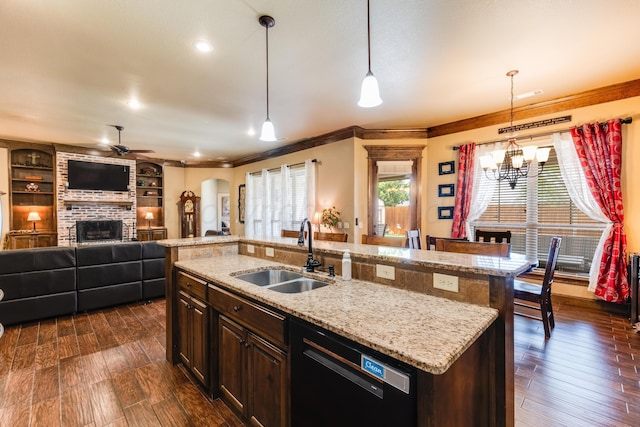 12 William Ln, Canyon, TX 79015 - kitchen with black dishwasher, a brick fireplace, a ceiling fan, arched walkways, and ornamental molding