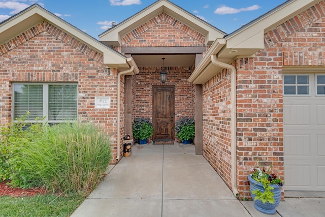 12 William Ln, Canyon, TX 79015 - view of exterior entry featuring brick siding and a garage