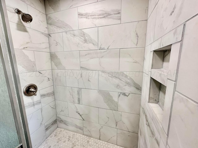 bathroom with a tile shower