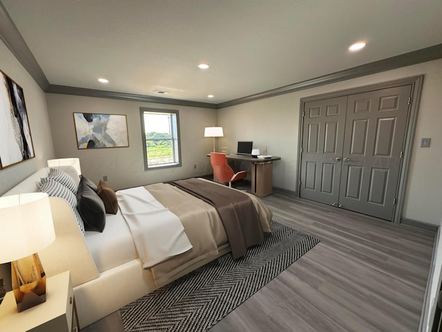 bedroom with ornamental molding, hardwood / wood-style floors, and a closet
