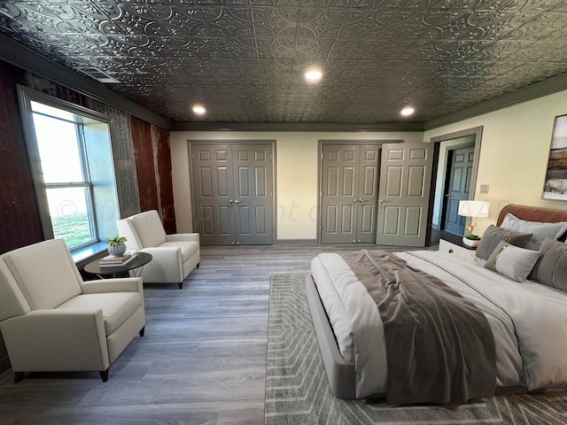 bedroom featuring hardwood / wood-style floors and ornamental molding