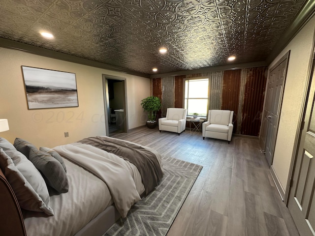bedroom with hardwood / wood-style flooring and ornamental molding