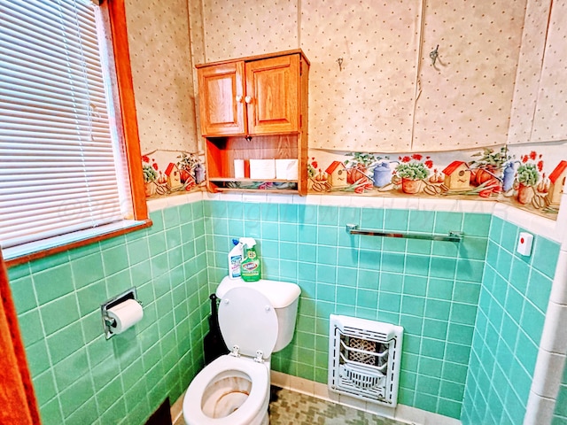 1301 S Fordham St, Perryton, TX 79070 - half bathroom with heating unit, tile walls, a wainscoted wall, and wallpapered walls