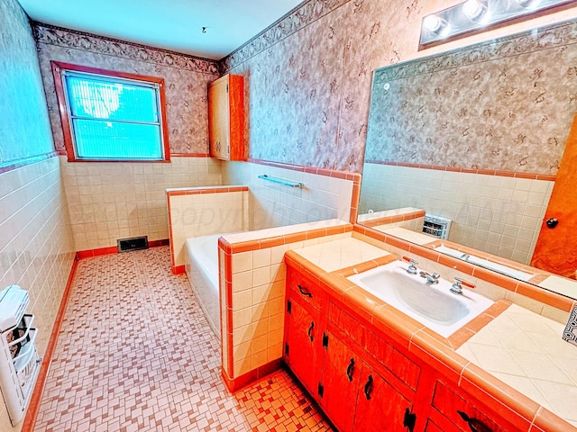 1301 S Fordham St, Perryton, TX 79070 - bathroom with tile walls, a bath, wallpapered walls, vanity, and heating unit