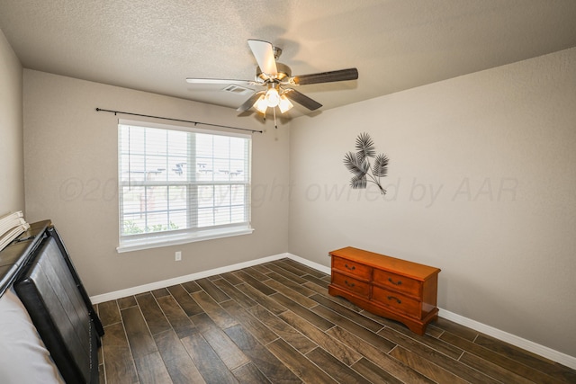 3001 Bismarck Ave, Amarillo, TX 79118 - unfurnished room featuring baseboards, dark wood-style flooring, and a ceiling fan