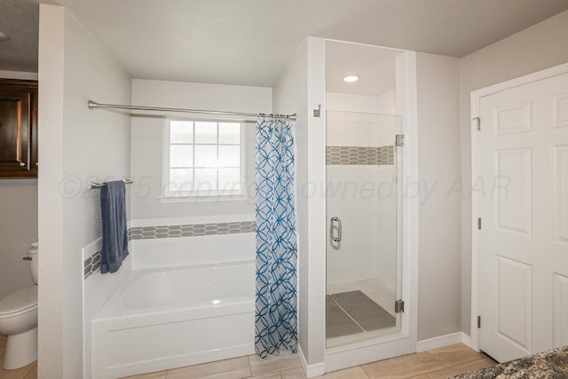 3001 Bismarck Ave, Amarillo, TX 79118 - bathroom with a stall shower, toilet, a tub to relax in, tile patterned flooring, and baseboards