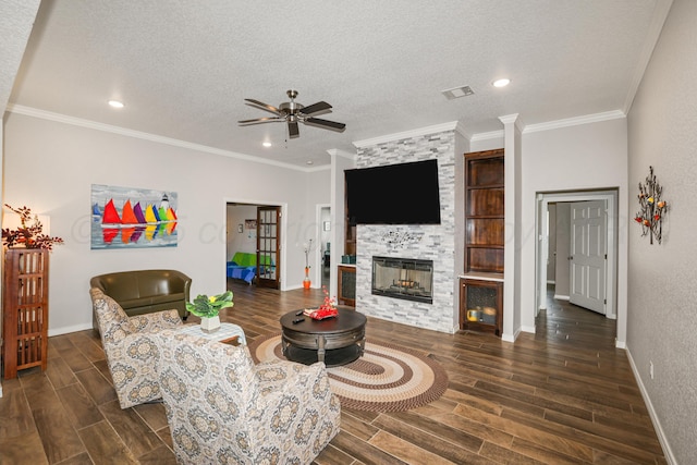 3001 Bismarck Ave, Amarillo, TX 79118 - living area featuring a ceiling fan, dark wood-type flooring, a fireplace, baseboards, and a textured ceiling