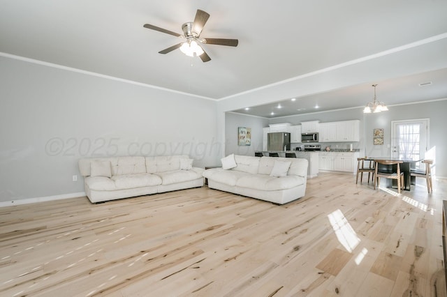 living room with crown molding, ceiling fan with notable chandelier, and light wood-type flooring