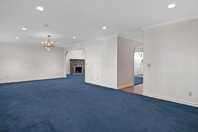 2614 Parker St, Amarillo, TX 79109 - unfurnished living room with arched walkways, recessed lighting, a fireplace with raised hearth, ornamental molding, and baseboards