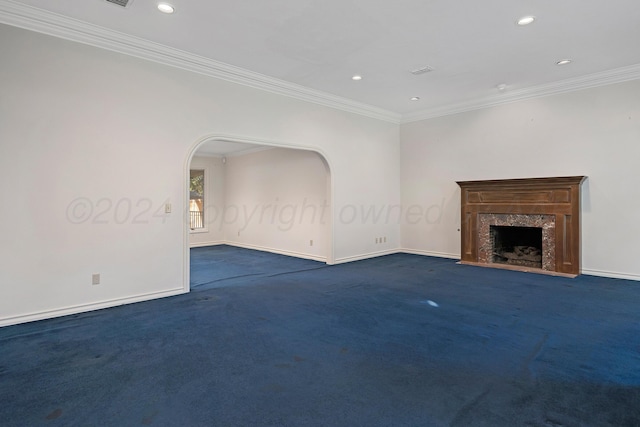 2614 Parker St, Amarillo, TX 79109 - unfurnished living room featuring ornamental molding, baseboards, recessed lighting, arched walkways, and carpet