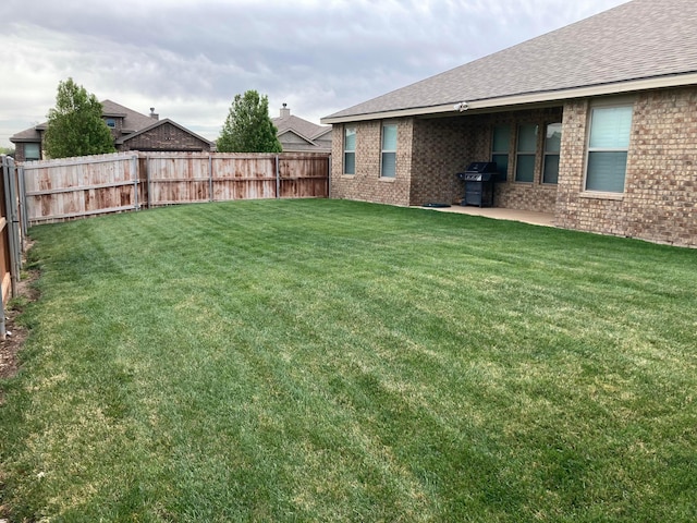 view of yard with a fenced backyard and a patio area