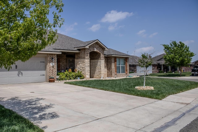 ranch-style home featuring a garage, brick siding, a front yard, and concrete driveway