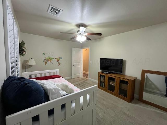 bedroom featuring visible vents, ceiling fan, light carpet, and baseboards