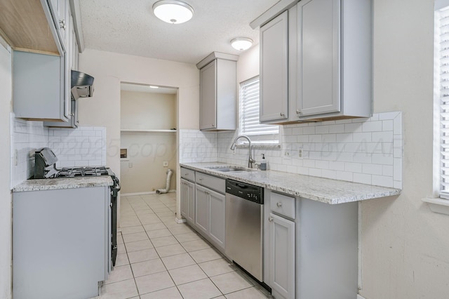 1736 Jennifer St, Amarillo, TX 79107 - kitchen with appliances with stainless steel finishes, gray cabinetry, light tile patterned floors, light countertops, and tasteful backsplash