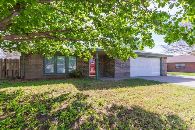 view of front of home with an attached garage, fence, brick siding, and concrete driveway