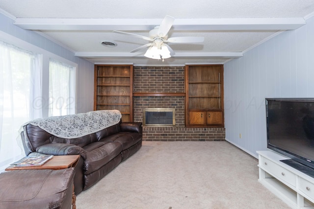carpeted living area with a brick fireplace, visible vents, a ceiling fan, beamed ceiling, and a textured ceiling